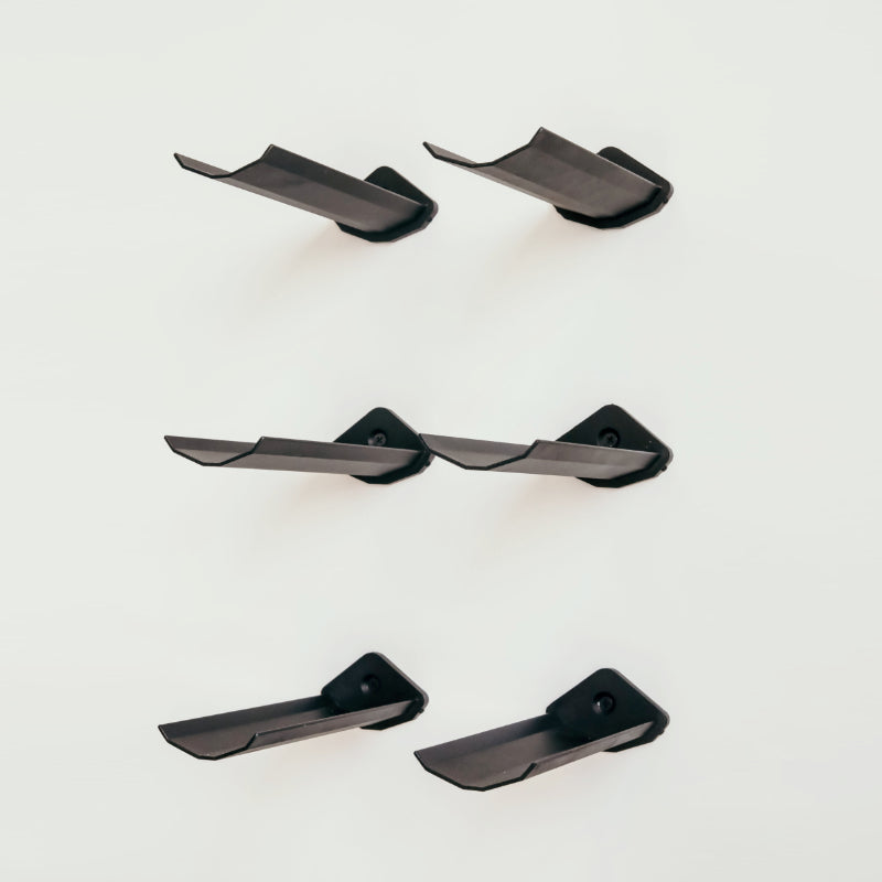 Set of black metal wine holders on a white background