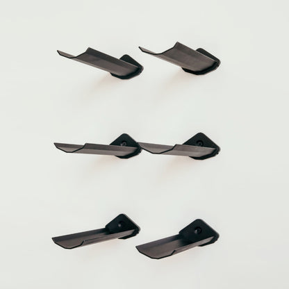 Set of black metal wine holders on a white background
