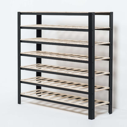 Black wine rack with multiple shelves on a white background