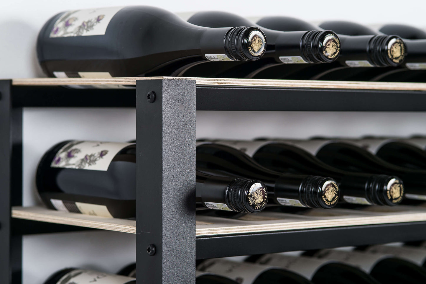 Close up image of the classic wine rack with black aluminium frame and raw birch shelves.