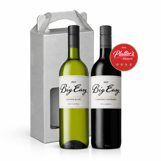Two wine bottles, one white and one red, with 'Big Easy' labels, in front of a gray gift box.