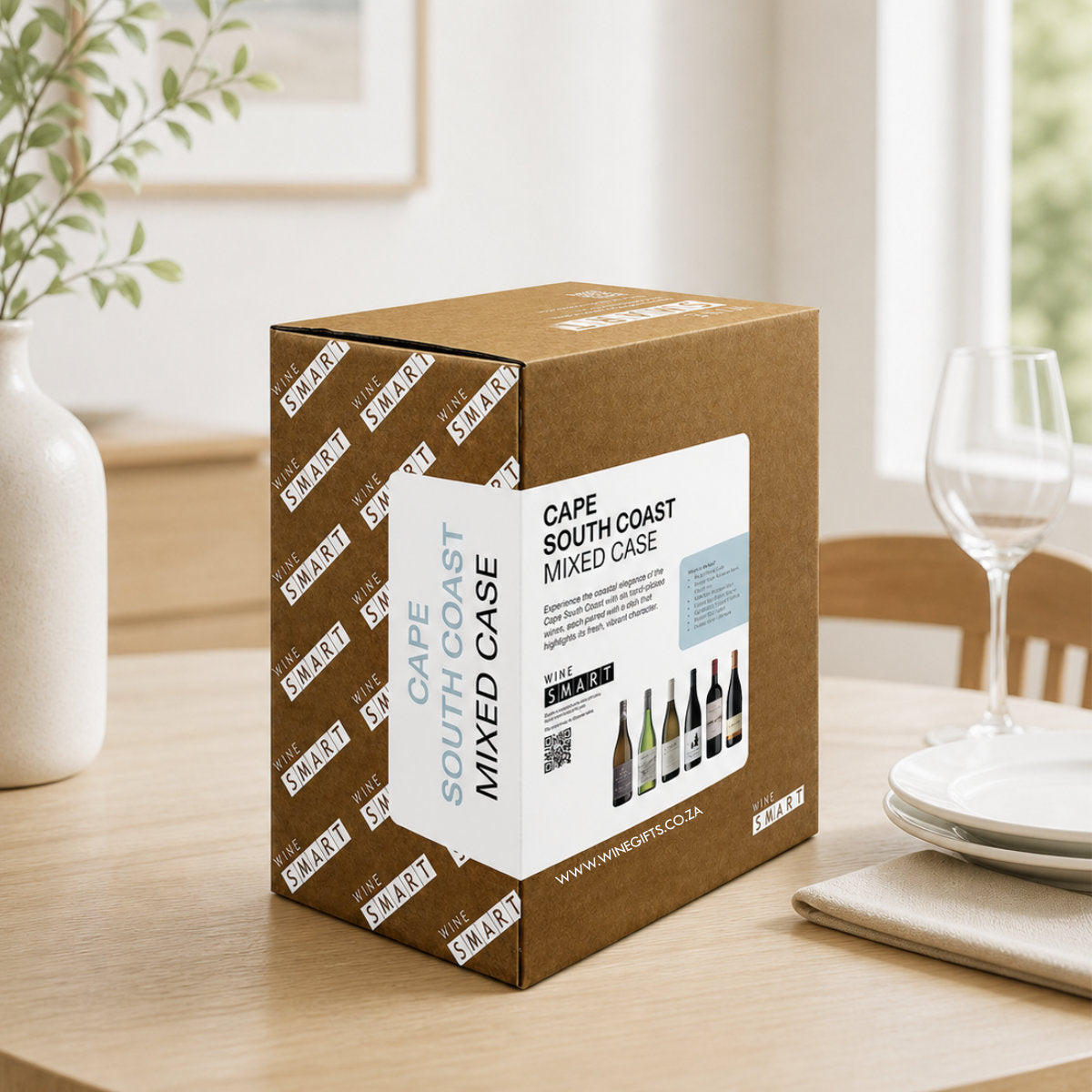Cape South Coast mixed case wine box on a table with a dining setup in the background