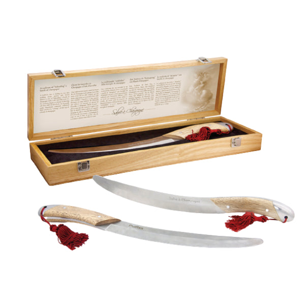 Two champagne sabres with wooden handles and red tassels on a white background, one in an open wooden box.