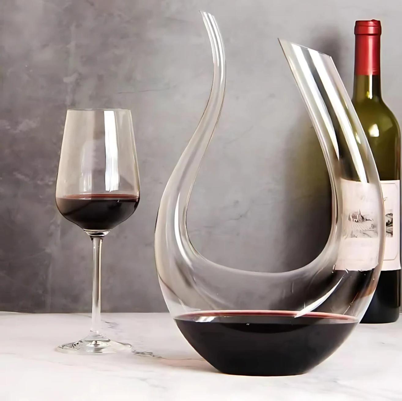 U-shaped wine decanter carafe with red wine inside.